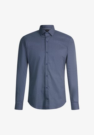 Chemise bleu marine à manches longues avec petits motifs géométriques blancs et col pointu.