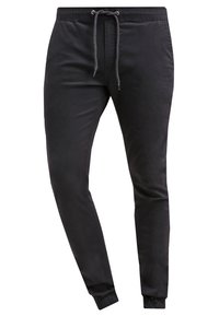 Černé zúžené tepláky se stahovacím páskem, elastickými manžetami a hladkým materiálem; navrženy pro pohodlí a přiléhavý vzhled.