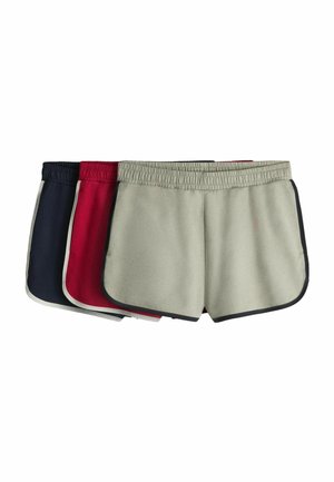 Three pairs of elastic waist athletic shorts stacked, in beige, red, and navy with contrasting trim.