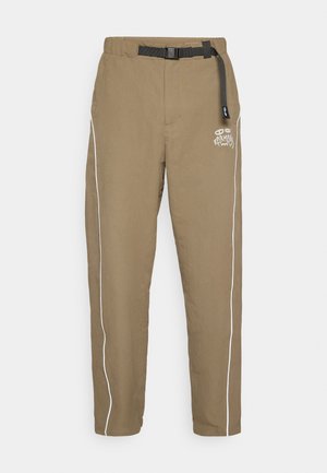 Khaki pants with a relaxed fit, featuring a black adjustable belt, white side stripes, and a logo on the front. Fabric appears lightweight and textured.