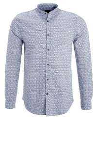 Blå skjorta med mandarin-krage, prydd med ett geometriskt mönster av cirklar och prickar. Långa ärmar och figursydd design.