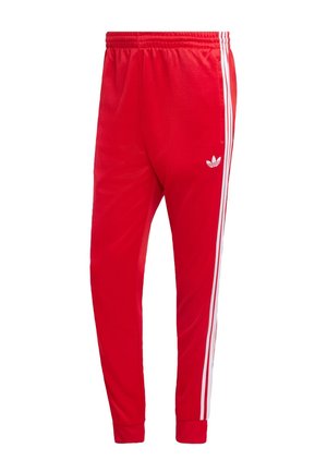 Pantaloni sportivi rossi in tessuto liscio, con strisce bianche laterali e logo ricamato sulla coscia sinistra. Vita elastica.