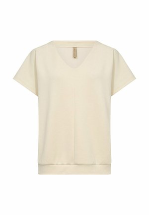Top a maniche corte con scollo a V in cotone color crema. Presenta una vestibilità rilassata e un orlo a coste con dettagli di cucitura minimi.