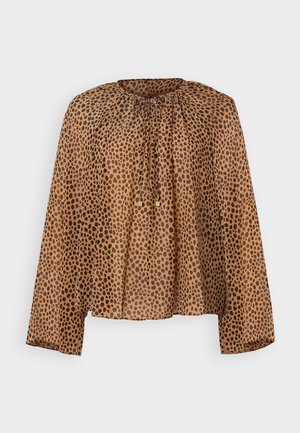 Blusa marrone a pois con scollatura rotonda, dettagli arricciati e maniche lunghe. Tessuto leggero e trasparente con vestibilità comoda.
