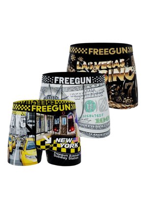 Trois paires de caleçons boxer aux thèmes de villes et d'argent : métro et taxis de New York, billet de cent dollars américain, et jetons de casino et machine à sous de Las Vegas.