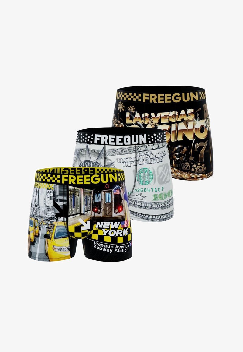 Trois paires de caleçons boxer aux thèmes de villes et d'argent : métro et taxis de New York, billet de cent dollars américain, et jetons de casino et machine à sous de Las Vegas.