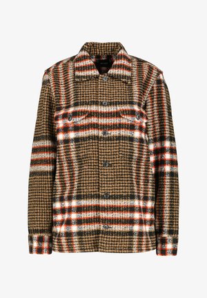 Veste en laine écossaise marron avec des accents beiges, rouges et blancs. Dotée d'une fermeture à boutons, de deux poches poitrine et d'un col pointu.