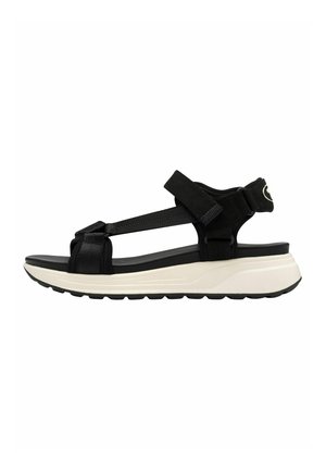 Black sandal with adjustable straps, featuring a chunky white sole and textured upper for added grip and comfort.