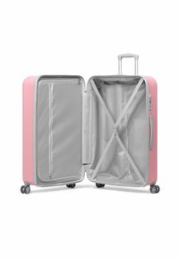 Hard-shell pink suitcase, featuring a grey interior, zipped compartment, cross-straps, and four spinner wheels for easy maneuverability.