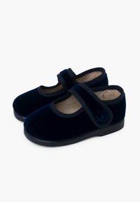 Zapatos de terciopelo azul marino con punta redonda, correa elástica y suela de goma. Forro interior suave y detalle de botón sutil en el lateral.