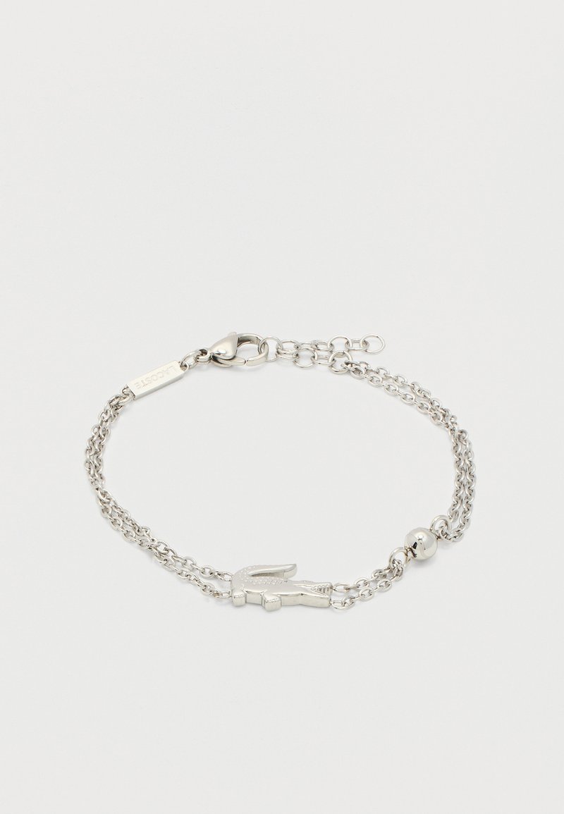 Ασημένιο βραχιόλι με διπλή αλυσίδα, κούμπωμα με καρφίτσα αστακού, ρυθμιζόμενους κρίκους, ένα μικρό στρογγυλό χάντρα και ένα μενταγιόν σε σχήμα κροκοδείλου.