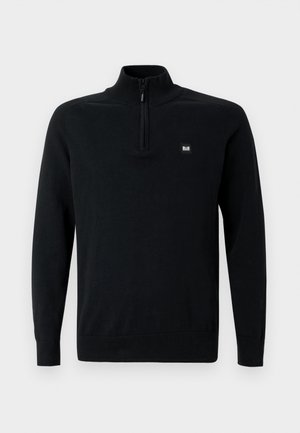 Maglione nero a collo alto, con zip frontale a metà, polsini e orlo a costine. Presenta una piccola etichetta con il logo sul lato sinistro.