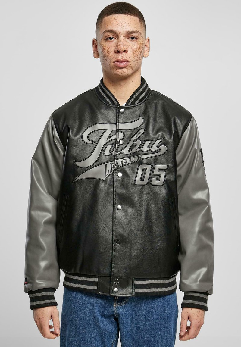 Black leather varsity jacket with gray sleeves, featuring a large graphic print and ribbed collar and cuffs. Buttons and side pockets included.