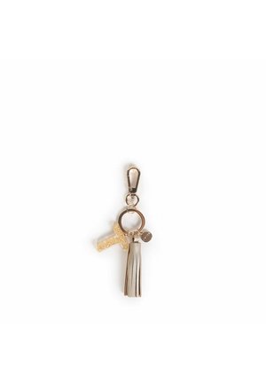 Portachiavi in metallo con clip oro, decorato con una lettera trasparente piena di glitter, frangia in finta pelle beige e un piccolo charm.