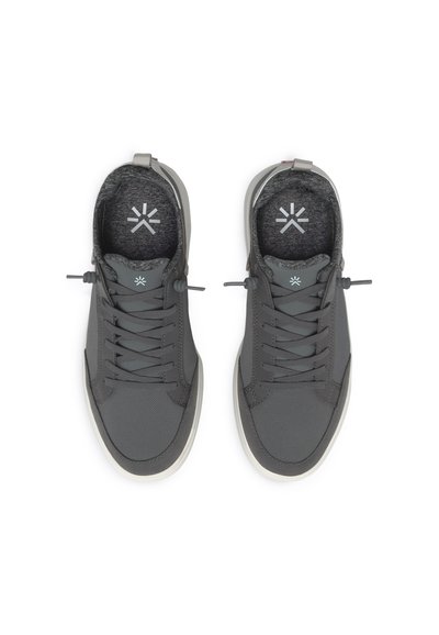 Gray athletic shoes with a textured upper, circular toe cap, and light-colored sole. Features elastic laces and a soft gray lining.