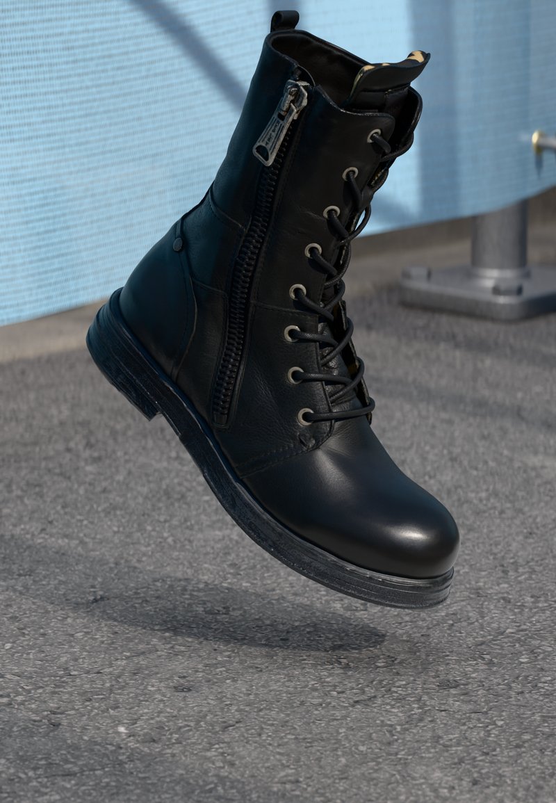 Black leather ankle boot featuring a lace-up front and side zipper, with a textured sole and smooth finish for durability.