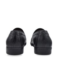 Black leather shoes with a smooth texture, rounded toe, low heel, and minimalistic design. Features subtle stitching on the sides.