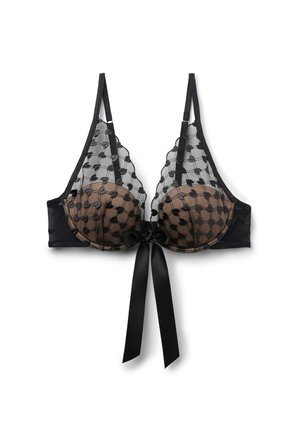 Černá průsvitná podprsenka s puntíkovanou síťovanou vrstvou, kosticemi, nastavitelnými ramínky a saténovou mašlí uvázanou uprostřed vpředu.