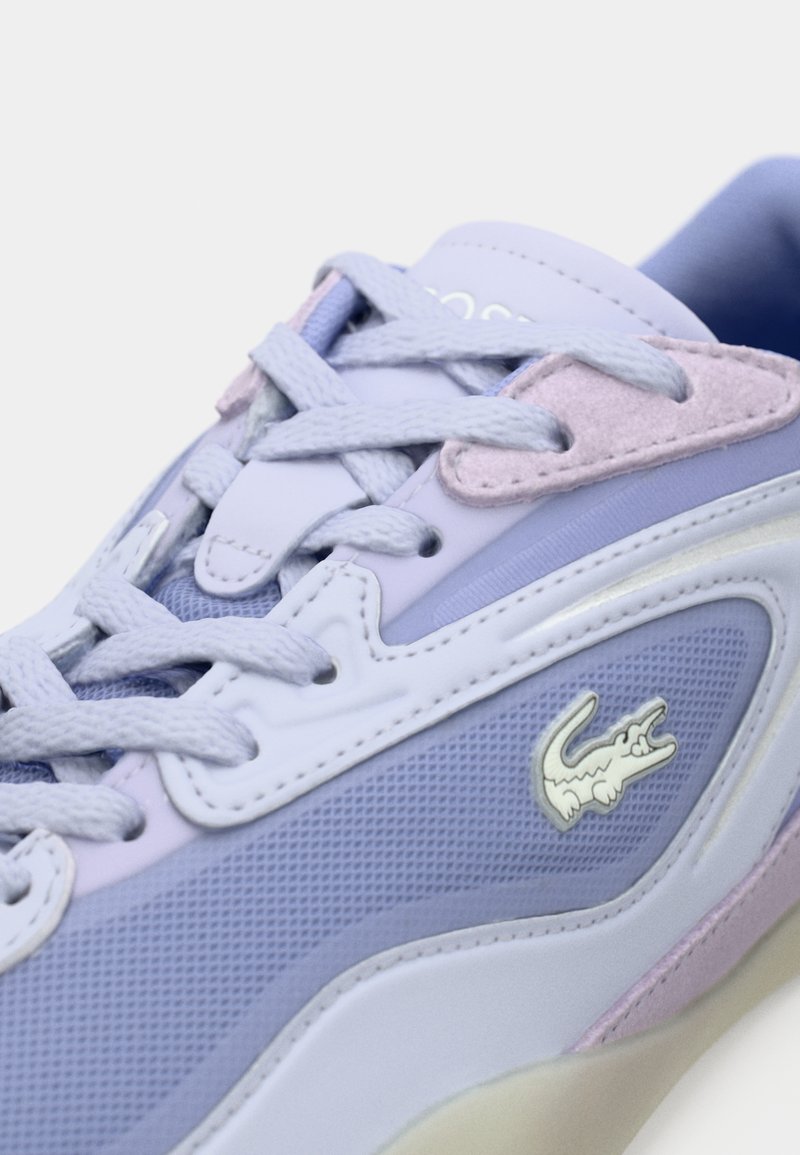 Lacoste sneakers in light purple and lavender with mesh and suede textures, featuring distinct logo accent, flat laces, and padded collar.