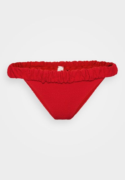 Red bikini bottom with ruffled elastic waistband, textured fabric, and a V-shaped cut, featuring solid color without patterns or additional details.