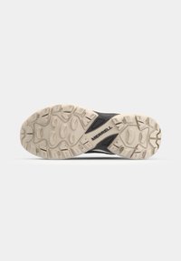 Merrell shoe outsole; textured rubber in cream and black; features grooves for grip; logo visible near heel; ergonomic design for traction.