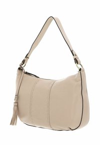 Sac à main en cuir beige doux avec bordure noire, forme incurvée, couture décorative et un accent de pompon sur le côté. Sangle d'épaule ajustée.