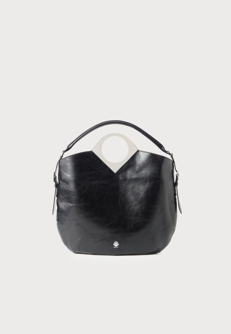 Black leather bag with a curved shape, circular top handle, and silver logo detail. Smooth texture and notable cut-out design feature.