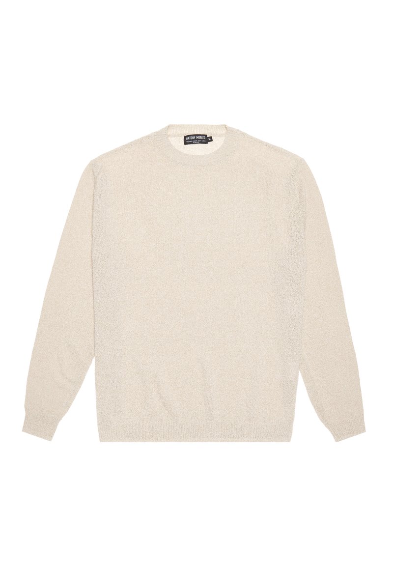 Krämfärgad tröja gjord av mjukt, texturerat material. Har långa ärmar, rund hals och ribbade muddar och fåll. Enkelt design.