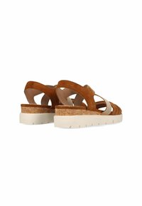 Braune Wildledersandalen mit einer Kork-Mittelsohle, elastischen Riemen und einer weißen Gummisohle. Offenes Design für Atmungsaktivität und Komfort.