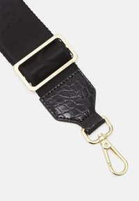 Adjustable black fabric strap with a gold metal buckle and a textured black faux leather end. Features a gold-tone clip for attachment.