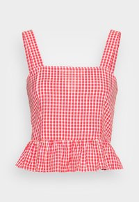 Haut court en vichy rouge et blanc avec larges bretelles, corsage ajusté et ourlet à volants. Confectionné en tissu léger.