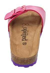 Rosa glidsandal med rem med spänne. Korkfotbädd och lila gummisula. Texturerad innersula med varumärkeslogotyp synlig.