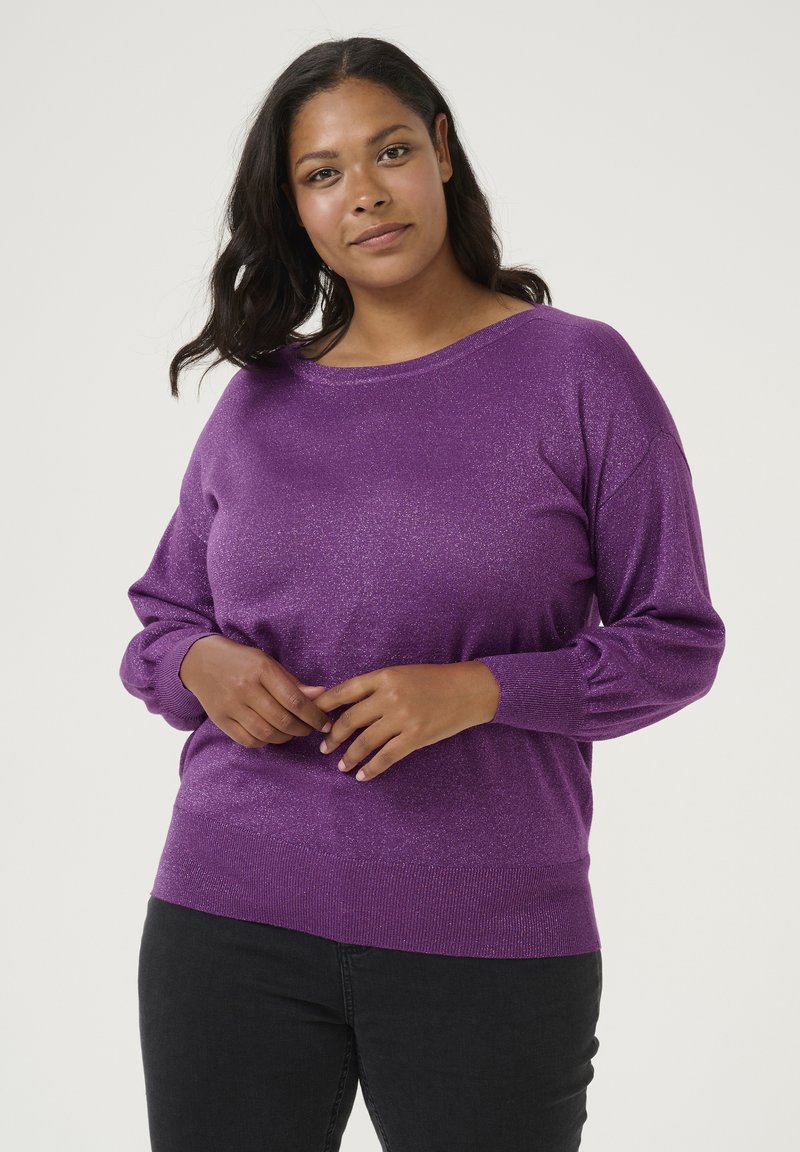 Purple glittery knit sweater with a wide neckline and long sleeves, featuring a ribbed hem and cuffs. Paired with black pants.