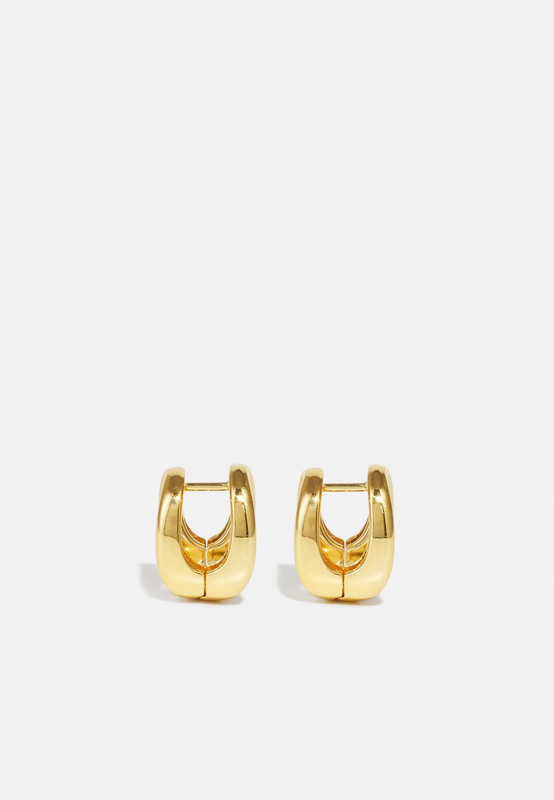Zlaté kruhové náušnice s elegantným, zaobleným dizajnom. Majú prázdne vnútro a lesklý povrch, ktorý dopĺňa moderné štýly.