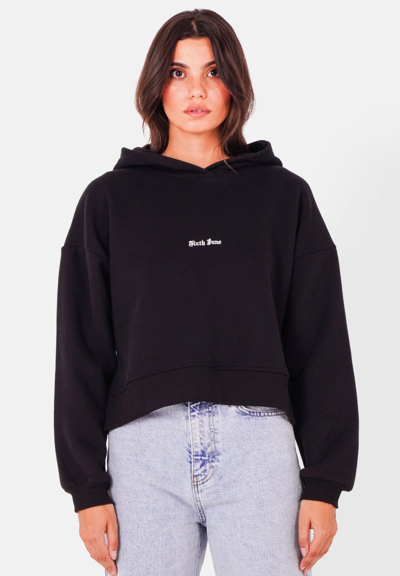 Svart cropped hoodie i mjukt material, med en framficka och vit "Sixth June" broderad logotyp på bröstet.