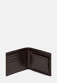 Brązowy skórzany portfel z wieloma miejscami na karty i boczną kieszenią. Gładka faktura, składana konstrukcja oraz widoczne detale przeszyć.