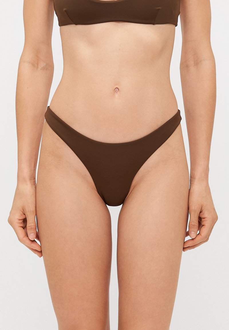 Brown bikini set featuring a minimalistic design with a scoop neckline and thin straps, made from a smooth, stretchy fabric.