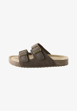 Brązowy sandał wsuwany z dwoma regulowanymi paskami na klamry i teksturowaną korkową podeszwą, zaprojektowany do noszenia na co dzień.