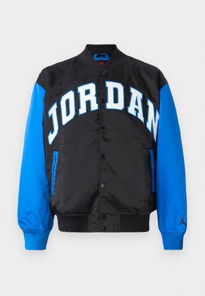 Black jacket with blue sleeves, featuring large white "JORDAN" lettering on the front, buttons down the center, and a logo on the right sleeve.