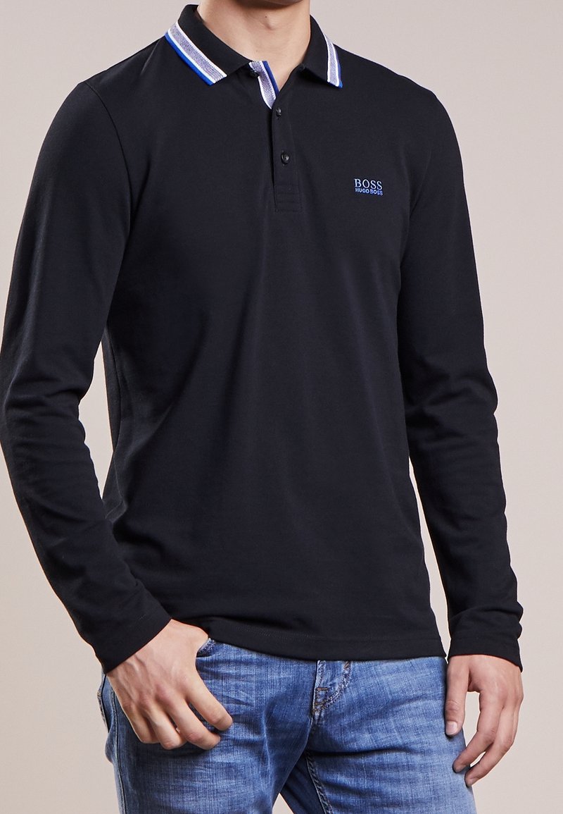 Black long-sleeve polo shirt with a striped collar in blue and white, featuring a subtle logo on the left chest and a smooth texture.