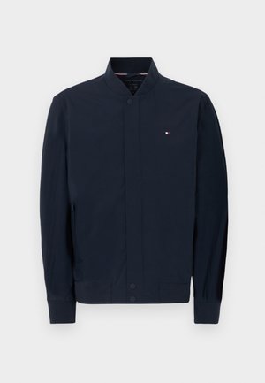 Marineblaue Bomberjacke mit geripptem Kragen und Bündchen, vorderer Druckknopfleiste, Seitentaschen und kleinem Tommy Hilfiger-Logo auf der Brust.