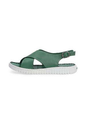 Grøn lædersandal med krydsdesign, hvid tekstureret sål, justerbar rem og åben tå.