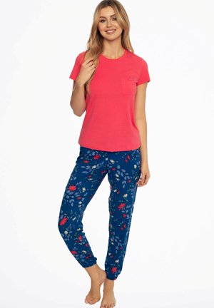 Short-sleeve coral T-shirt with a pocket paired with blue floral print jogger pants; lightweight, soft fabric, elastic cuffs, and vibrant pattern details.