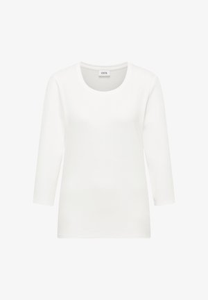 Witte katoenen longsleeve t-shirt met ronde hals, gladde textuur en een ontspannen pasvorm. Merkenlabel "CECI" is zichtbaar bij de hals.