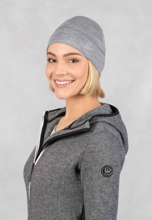 Gray beanie with a tight, smooth texture, featuring a subtle logo on the side. Worn with a gray zip-up hoodie. Soft, casual design.