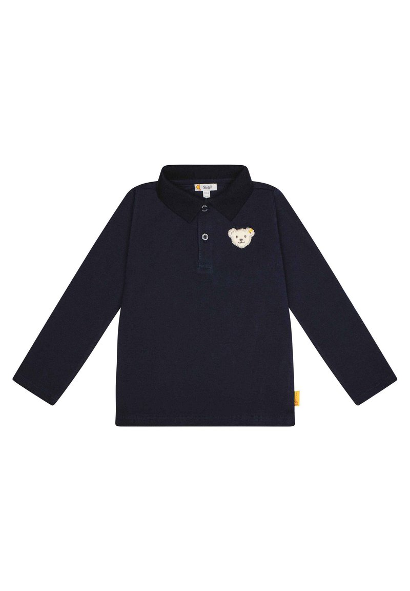 Marineblauwe polo met lange mouwen en kraag, voorzien van een geborduurd berenpatch op de borst en een klein geel label aan de zijkant.
