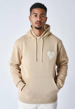 Sudadera beige hecha de una mezcla de algodón, cuenta con un bolsillo frontal, capucha con cordones y un detalle de corazón bordado en el pecho.