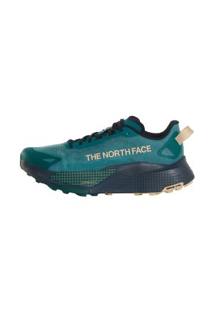 Scarpa da trail running The North Face turchese e nera con dettagli beige, design a griglia sulla suola e chiusura con lacci.