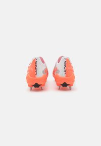 Purple and orange soccer cleats with a textured upper, black accents, and metallic studs on the sole for traction; lightweight design.