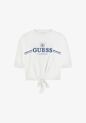 T-shirt blanc court avec texte et logo bleu marine « GUESS California Sports Club », avec nœud noué à l'avant et manches courtes.